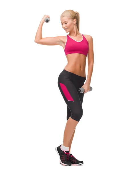 Young sporty woman with light dumbbells — Stock Photo, Image