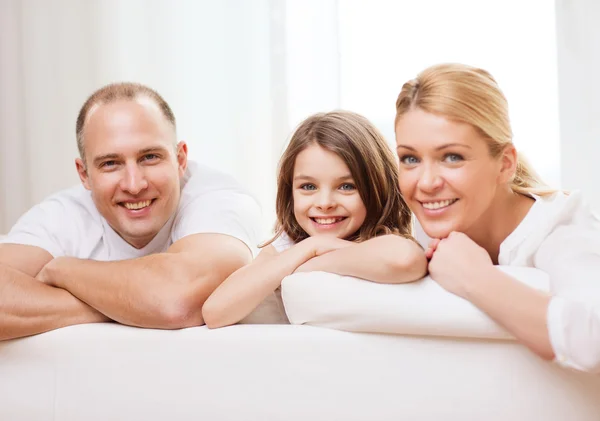 Smiling parents and little girl at home — Stock Photo, Image