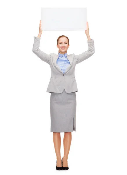 Smiling businesswoman with white blank board — Stock Photo, Image