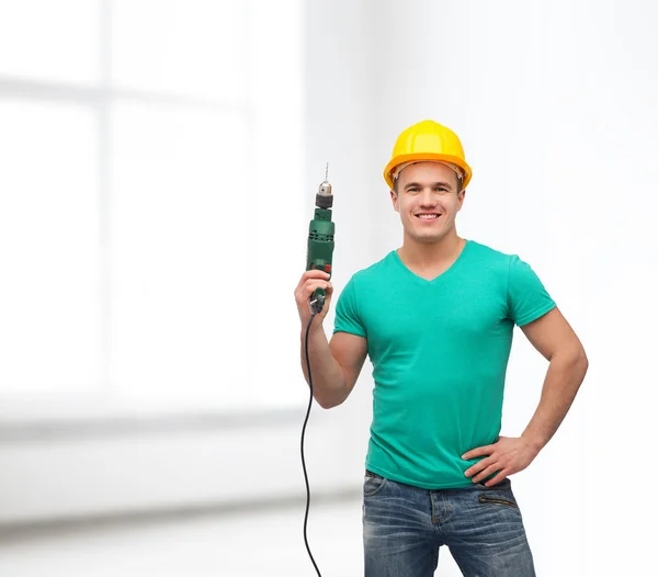 Trabajador manual sonriente en casco con máquina perforadora — Foto de Stock