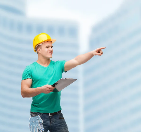 Smiling man in helmet with clipboard — Stock Photo, Image