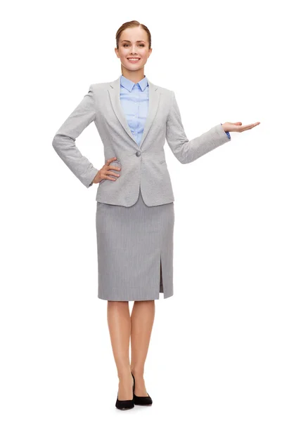 Businesswoman showing something on her hand — Stock Photo, Image