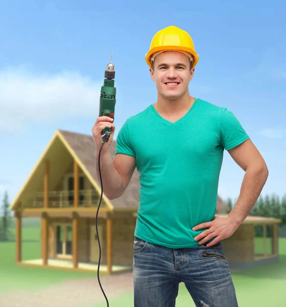 Trabajador manual sonriente en casco con máquina perforadora — Foto de Stock