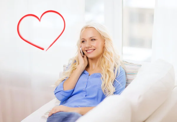 Mujer sonriente con smartphone en casa — Foto de Stock