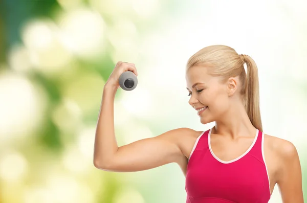 Young sporty woman with light dumbbell — Stock Photo, Image