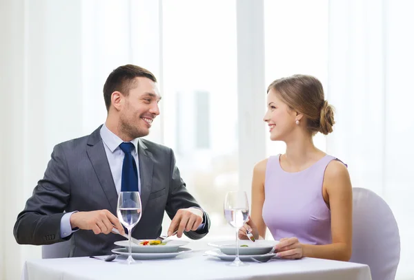 Lächelndes Paar isst Häppchen im Restaurant — Stockfoto
