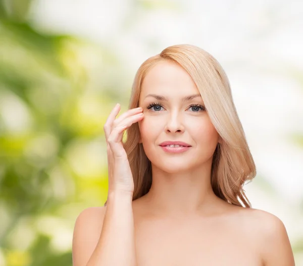 Beautiful woman touching her eye area — Stock Photo, Image