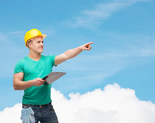 Smiling man in helmet with clipboard — Stock Photo, Image