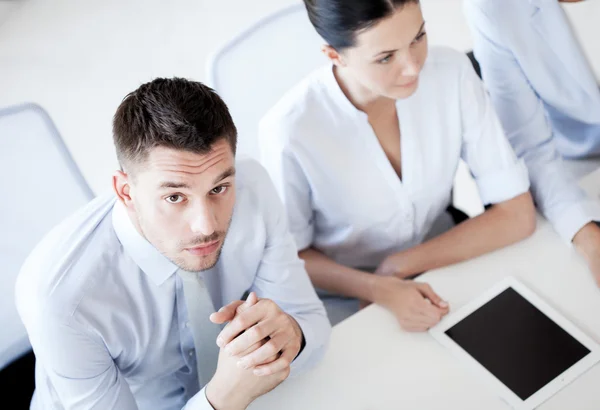 Serious businessman on meeting in office — Stock Photo, Image