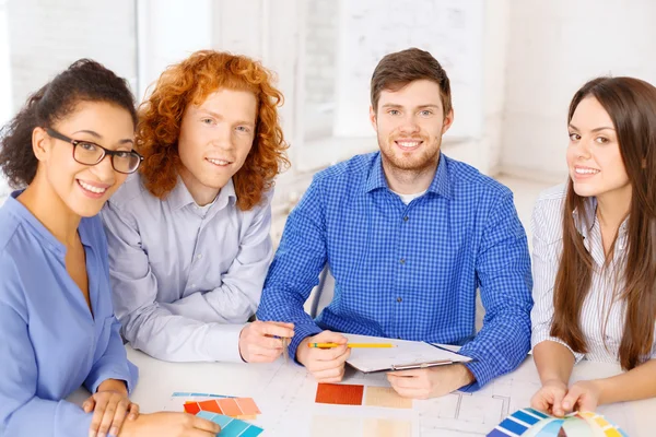 Team with color samples and blueprint at office — Stock Photo, Image