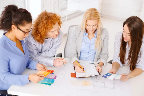 Team with color samples and blueprint at office — Stock Photo, Image