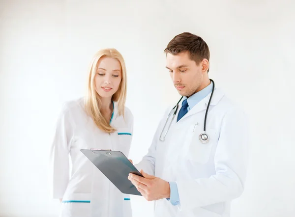 Young male doctor and female nurse in hospital — Stock Photo, Image