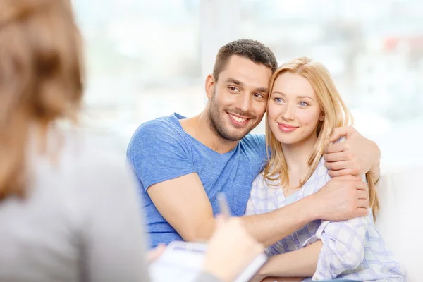 Young couple hugging at psychologist office — Stock Photo, Image