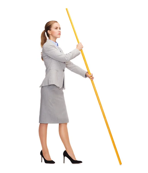 Calm woman holding flagpole with imaginary flag — Stock Photo, Image