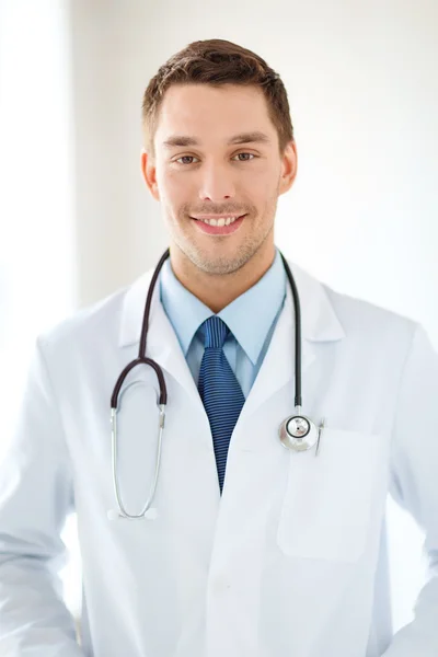 Young male doctor with stethoscope in hospital Royalty Free Stock Photos