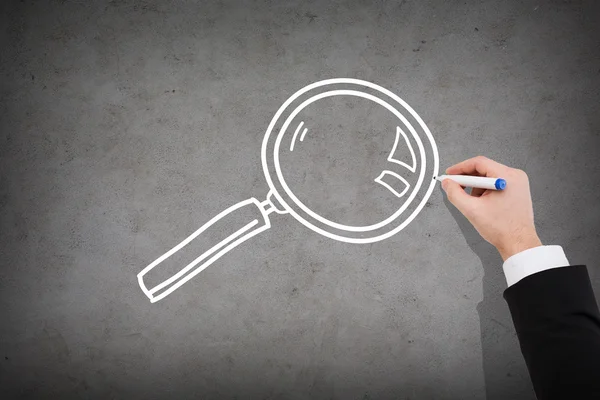 Close up of businessman drawing magnifying glass — Stock Photo, Image