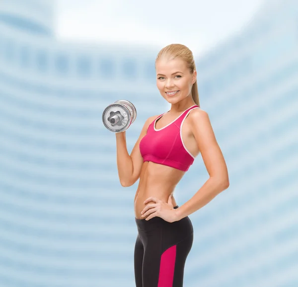 Smiling woman with heavy steel dumbbell — Stock Photo, Image