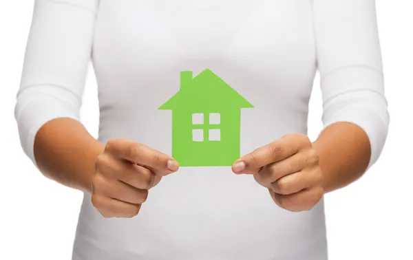 Woman hands holding green house — Stock Photo, Image