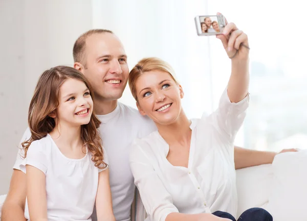 Happy family with little girl making self portrait — Stock Photo, Image