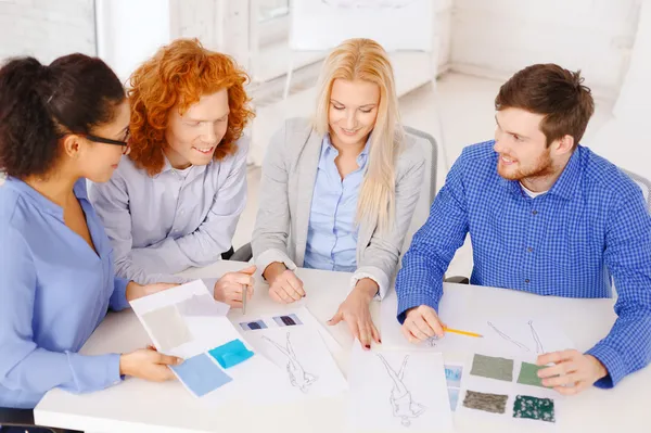 Smiling creative team looking at sketch — Stock Photo, Image