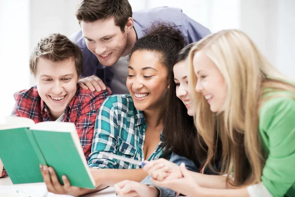Students reading book at school — Stock Photo, Image