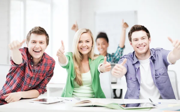 Students showing thumbs up at school — Stock Photo, Image