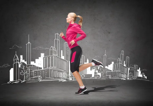 Sportliche Frau läuft oder springt — Stockfoto
