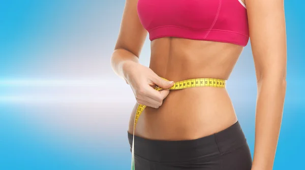 Close up trained belly with measuring tape — Stock Photo, Image