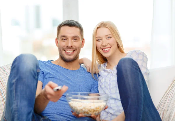 Sorrindo casal com pipocas assistindo filme em casa — Fotografia de Stock