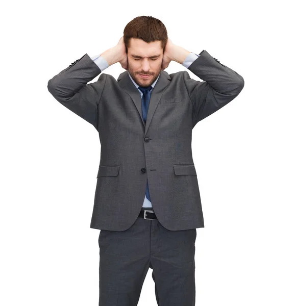 Hombre de negocios molesto cubriendo oídos con sus manos — Foto de Stock