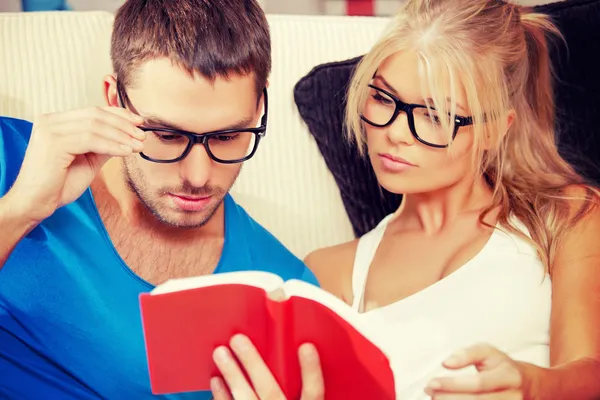 Couple at home with book — Stock Photo, Image