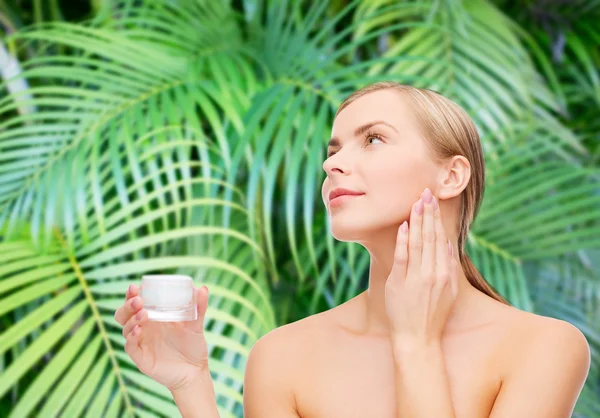 Woman applying cream on her skin — Stock Photo, Image