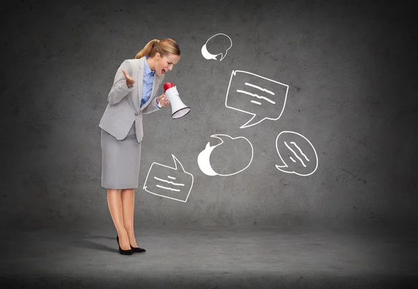 Angry businesswoman with megaphone — Stock Photo, Image