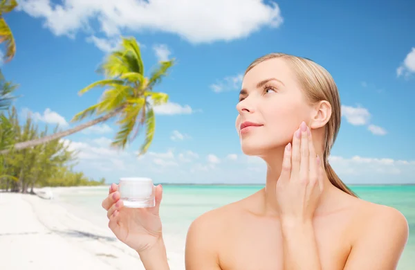 Woman applying cream on her skin — Stock Photo, Image