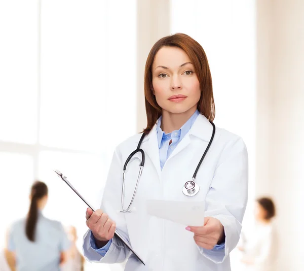 Calm female doctor with clipboard — Stock Photo, Image