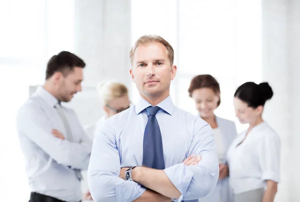 Handsome businessman with team in office — Stock Photo, Image