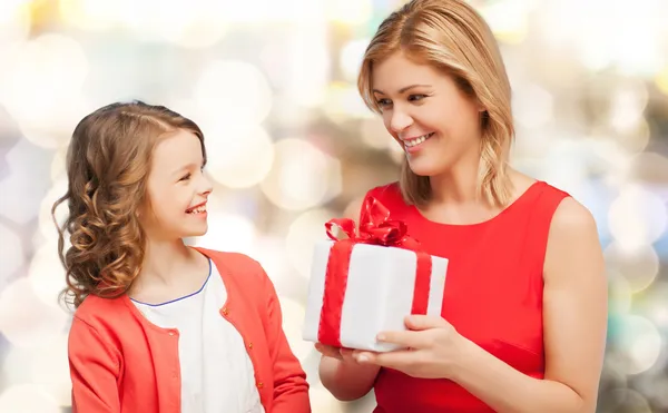 Smiling mother and daughter with gift box Stock Picture