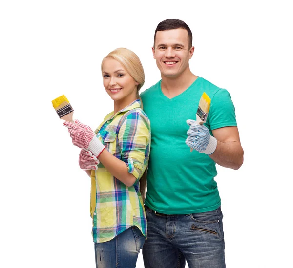 Smiling couple with paintbrush — Stock Photo, Image