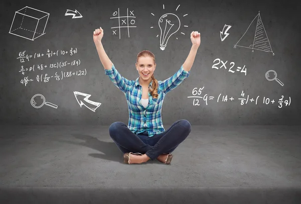 Young woman in casual clothes sitting on floor — Stock Photo, Image