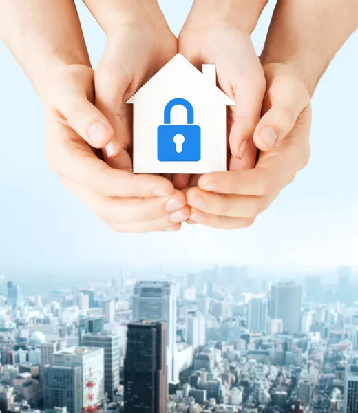 Hands holding paper house with lock — Stock Photo, Image