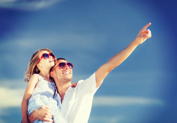 Gelukkig vader en kind in zonnebril over blauwe hemel — Stockfoto
