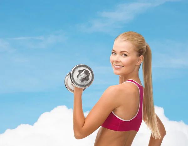 Smiling woman with heavy steel dumbbell — Stock Photo, Image