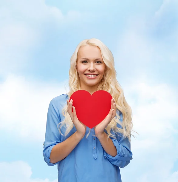 Smiling woman with red heart — Stock Photo, Image