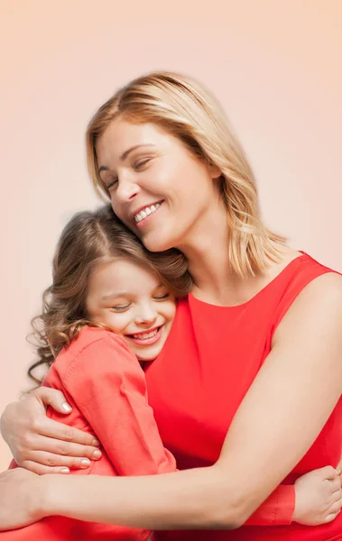 Улыбающиеся мать и дочь обнимаются — стоковое фото