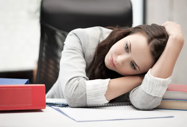 Bored and tired woman behid the table — Stock Photo, Image