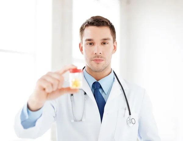 Male doctor with jar of capsules — Stock Photo, Image