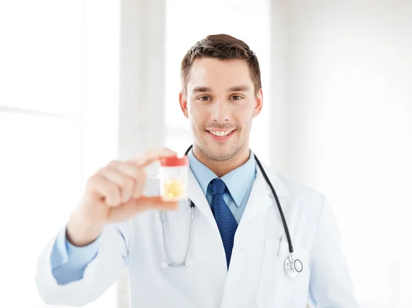 Male doctor with jar of capsules — Stock Photo, Image