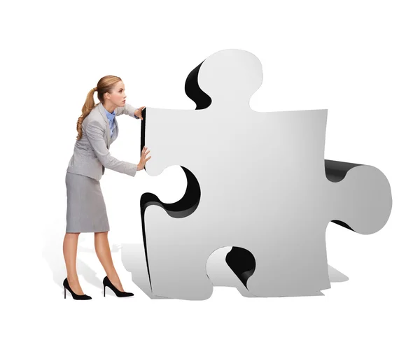 Busy businesswoman pushing puzzle piece — Stock Photo, Image