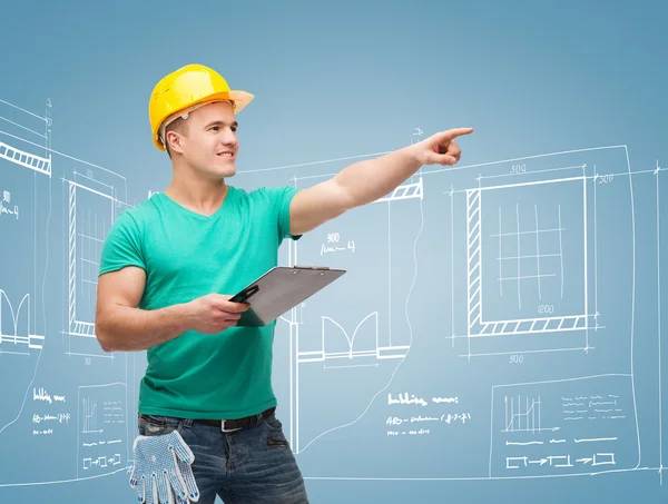 Smiling man in helmet with clipboard — Stock Photo, Image