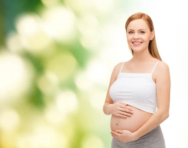 Feliz futura madre tocando su vientre —  Fotos de Stock